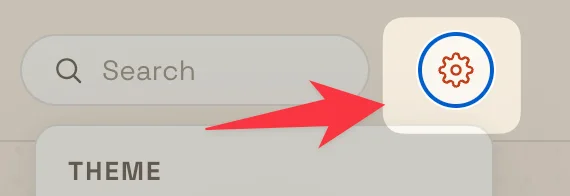 The settings gear at the top right of the nav, next to the search box, with an arrow pointing to it.